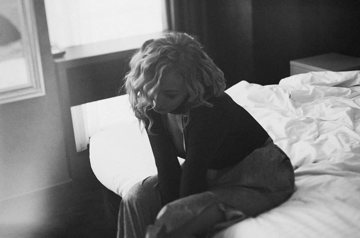 Kseniya Wagner seated in a quiet monochrome interior
